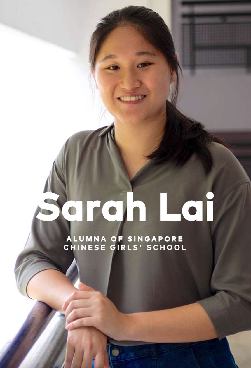 Sarah Lai, alumna of Singapore Chinese Girls' School, smiling woman in gray top leaning on a railing.