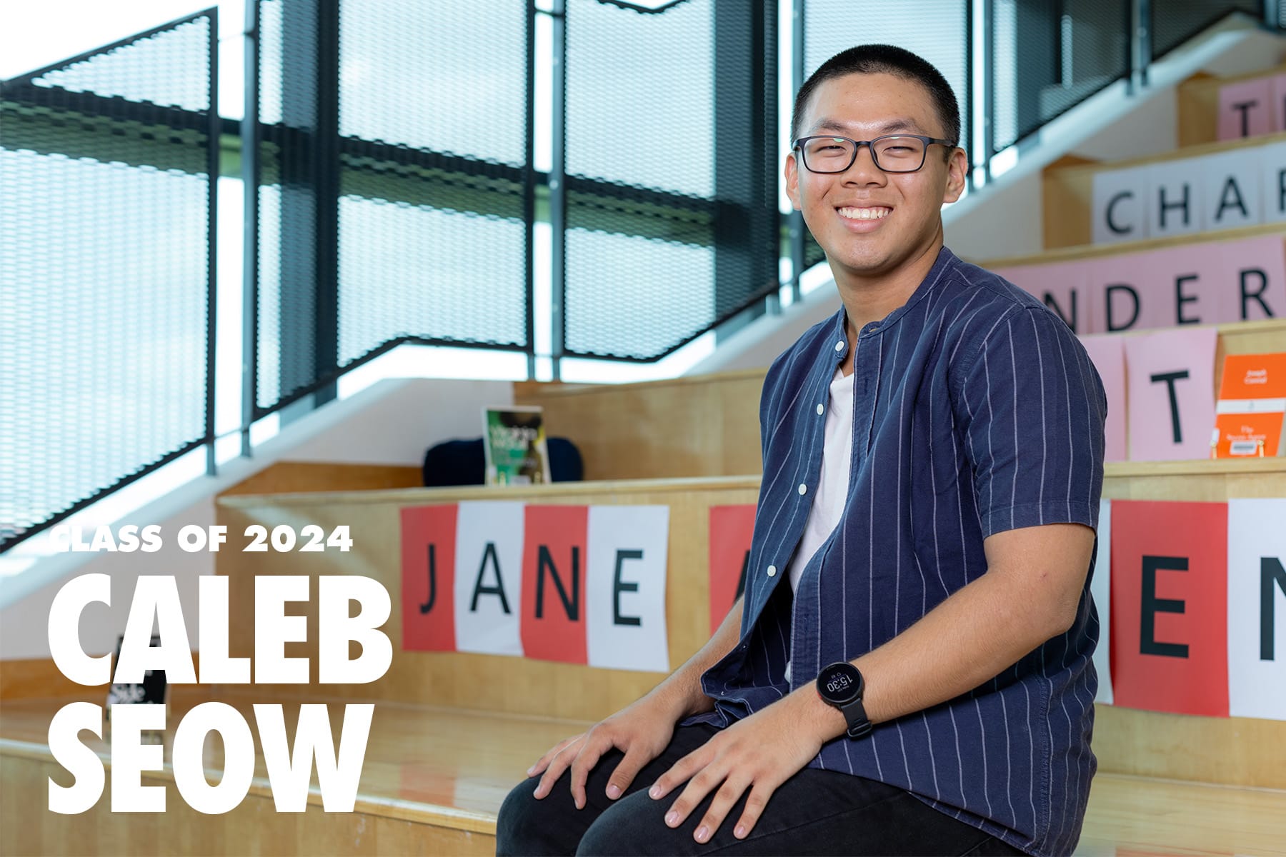 Caleb Seow, Class of 2024, smiling young man with glasses sitting on wooden steps indoors.