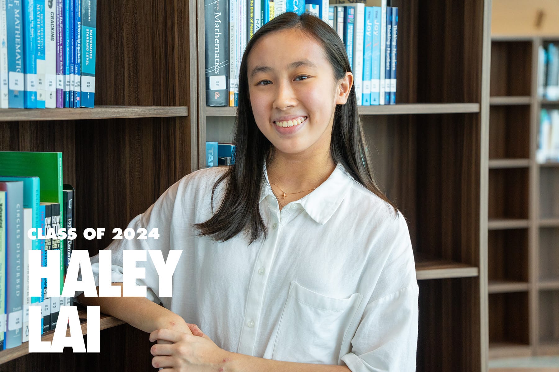 Smiling young woman in a white shirt stands before a bookshelf, labeled Class of 2024 Haley Lai.