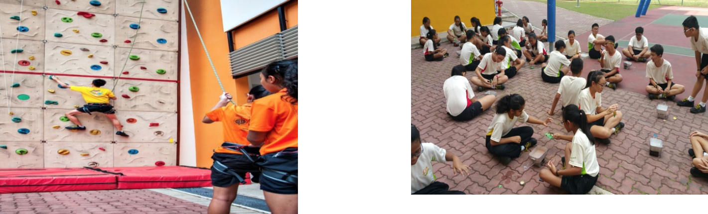 A child climbs a colorful wall while an instructor belays; students sit on a courtyard doing a group activity.