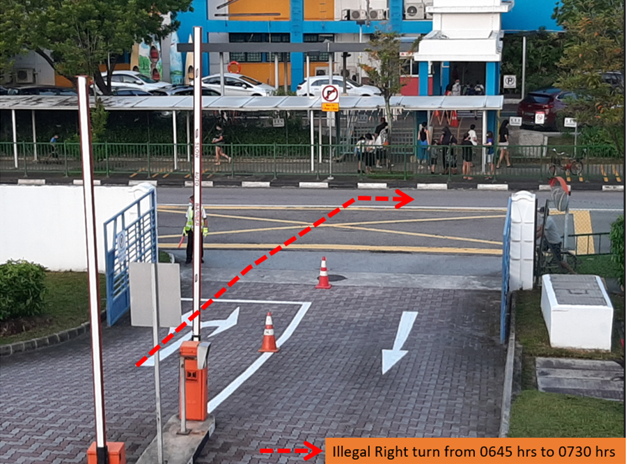 A gated driveway with traffic cones and a notice warning that right turns are illegal from 0645 to 0730 hrs.
