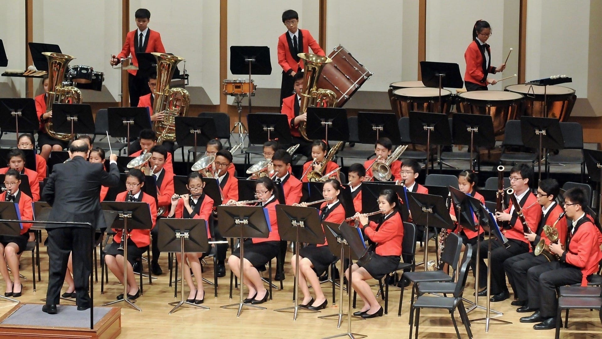 Band performance with instructor conducting