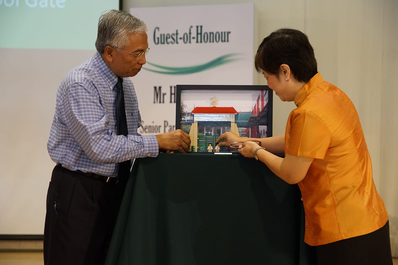 Mrs. Daphne Sing, 11th Principal of De La Salle school and Guest-of-Honour Mr. Hawazi Daipi, Senior Parliamentary Secretary, Ministry of Education officiating the opening of the new campus after PRIME upgrading (2014).