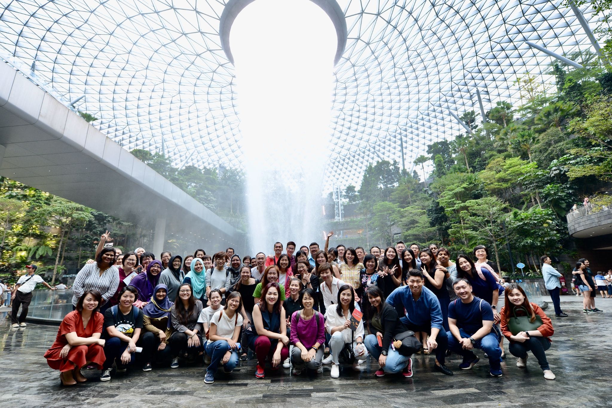 Staff photograph taken at Jewel Changi Airport Rain Vortex on 19 Nov 2019 during the team building segment of our End-of-Year Staff Seminar.