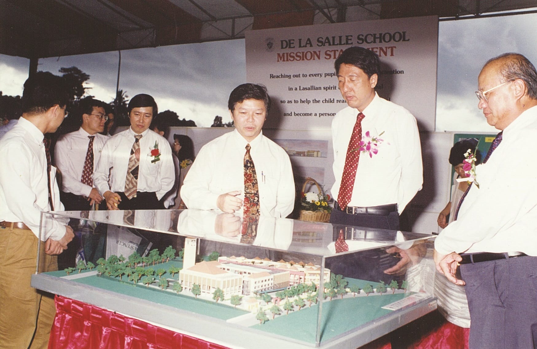 VIPs looking at the model of the Choa Chu Kang campus of De La Salle School before during the groundbreaking ceremony (1995).