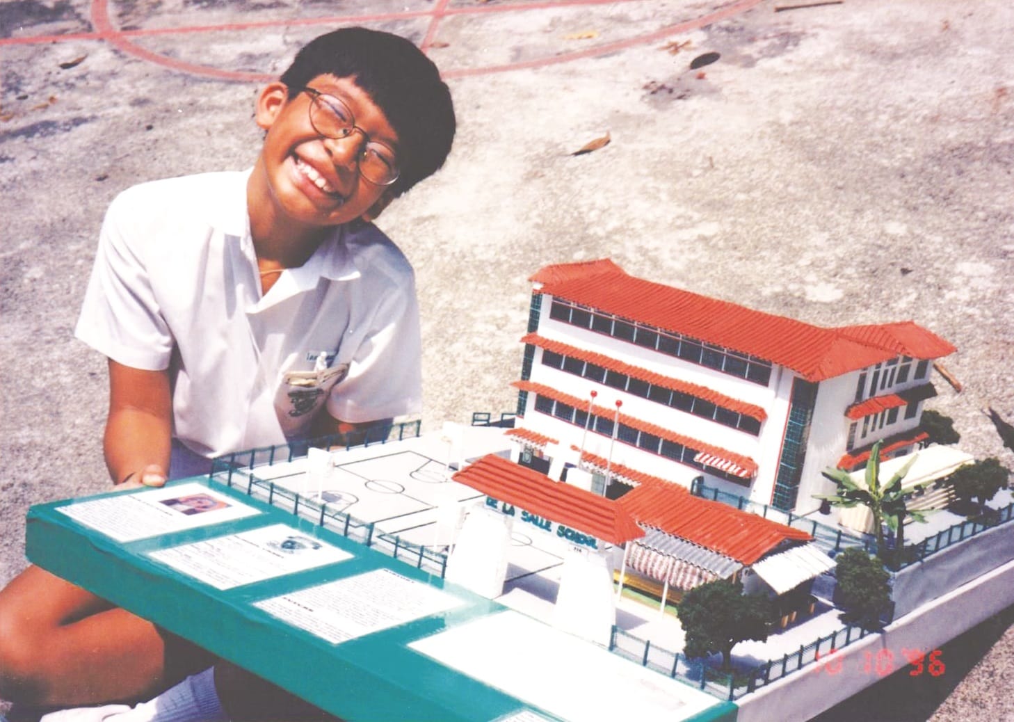 A Lasallian with a model of the Kampong Bahru campus (1970s – 1980s).