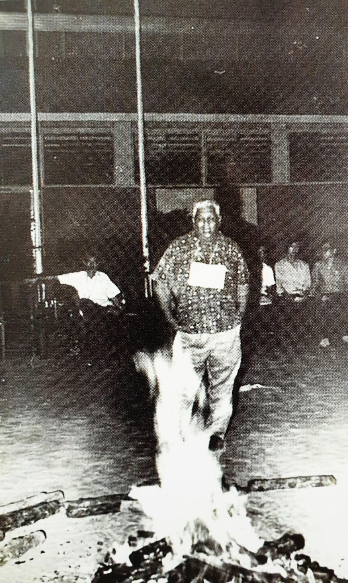 The late Principal Mr. Adbul Karim Bagoo, observing a Uniformed Group Camp fire night (1970).