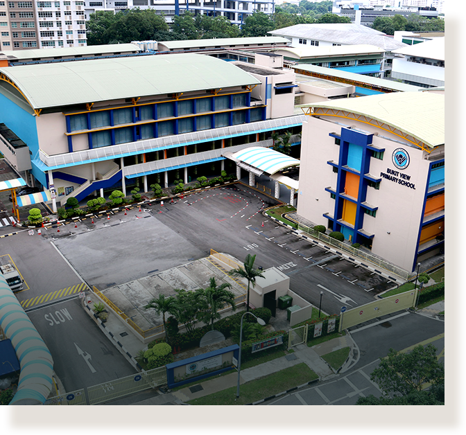 Aerial view of Bukit View Primary School with colorful blue and orange buildings and a parking area.