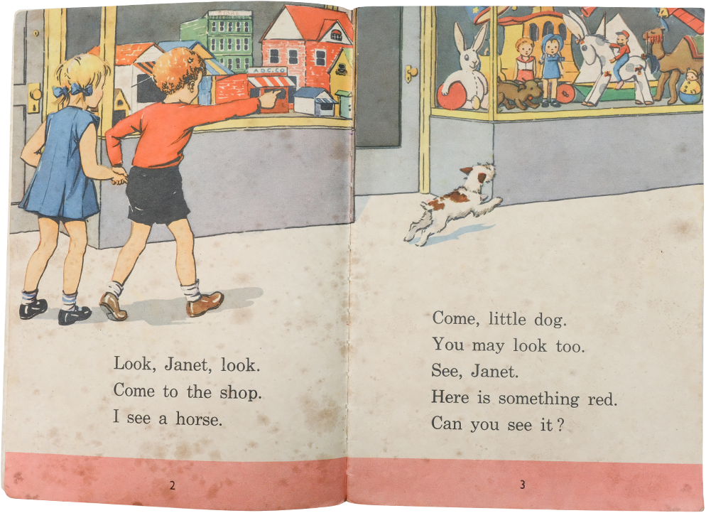 Open children's book showing two kids pointing at a toy shop window, a small dog running, with simple reading text.