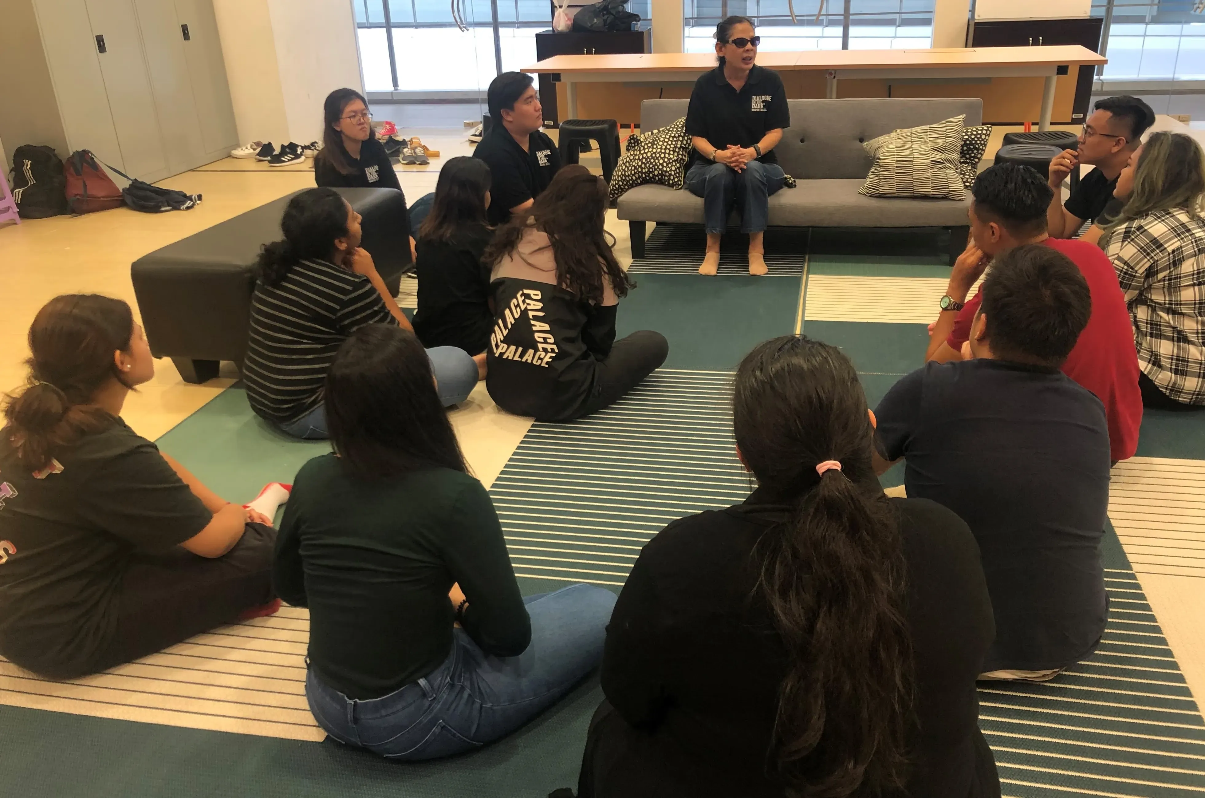 Students hearing from a visually-impaired guide.