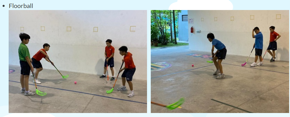 Boys playing floorball indoors, holding colorful sticks near a small pink ball on a court floor.