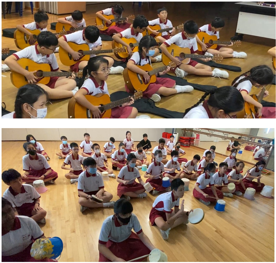 Children in school uniforms sit on floors playing acoustic guitars above, and beating bucket drums below.