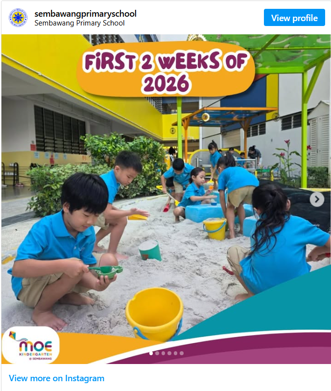 Instagram post from sembawangprimaryschool titled "First 2 Weeks of 2026" (MOE Kindergarten @ Sembawang), showing several children in blue uniforms playing barefoot in a sandpit with buckets and shovels, in a colorful outdoor play area with yellow, green, and blue structures.