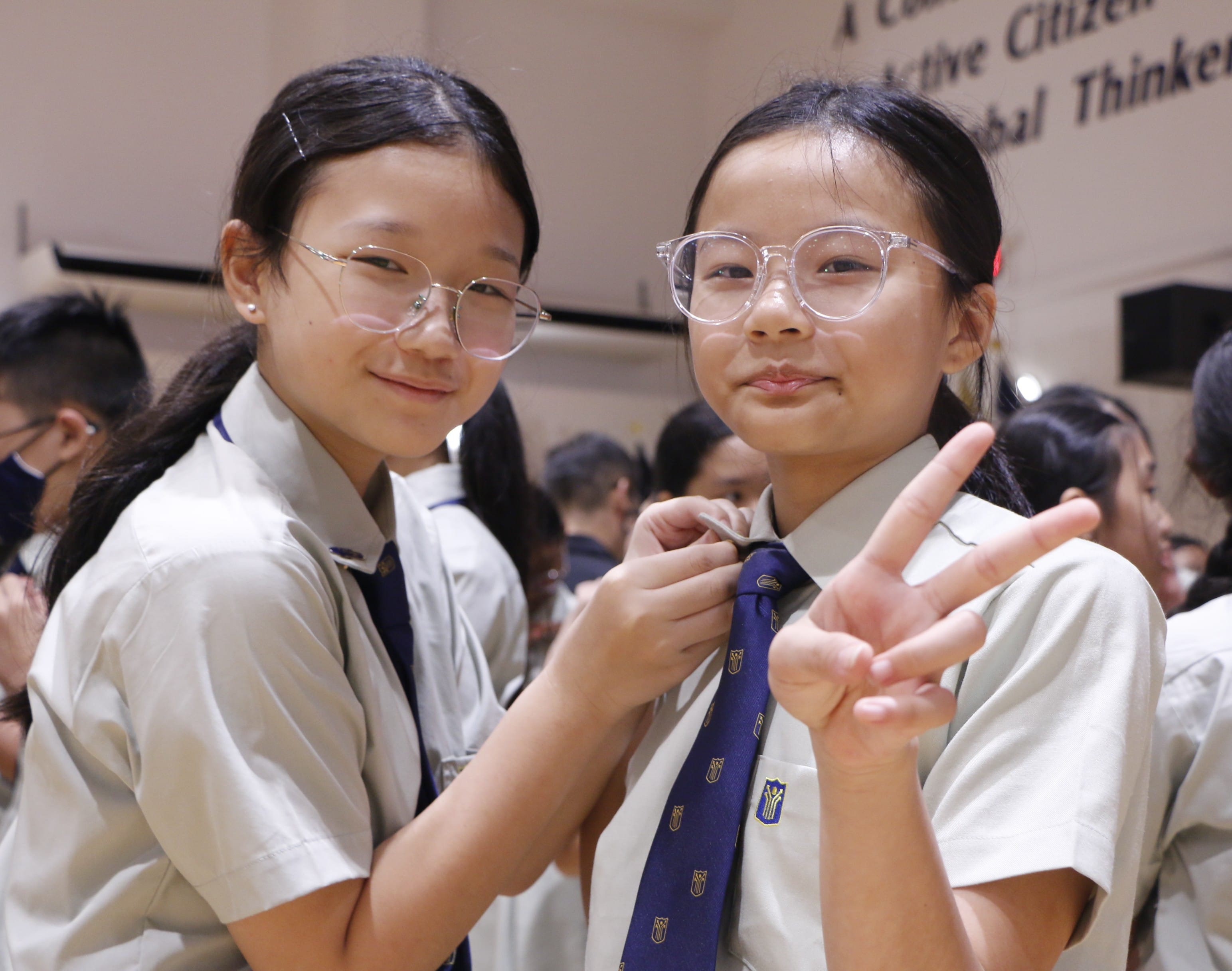 Students wearing their school uniform and tie.