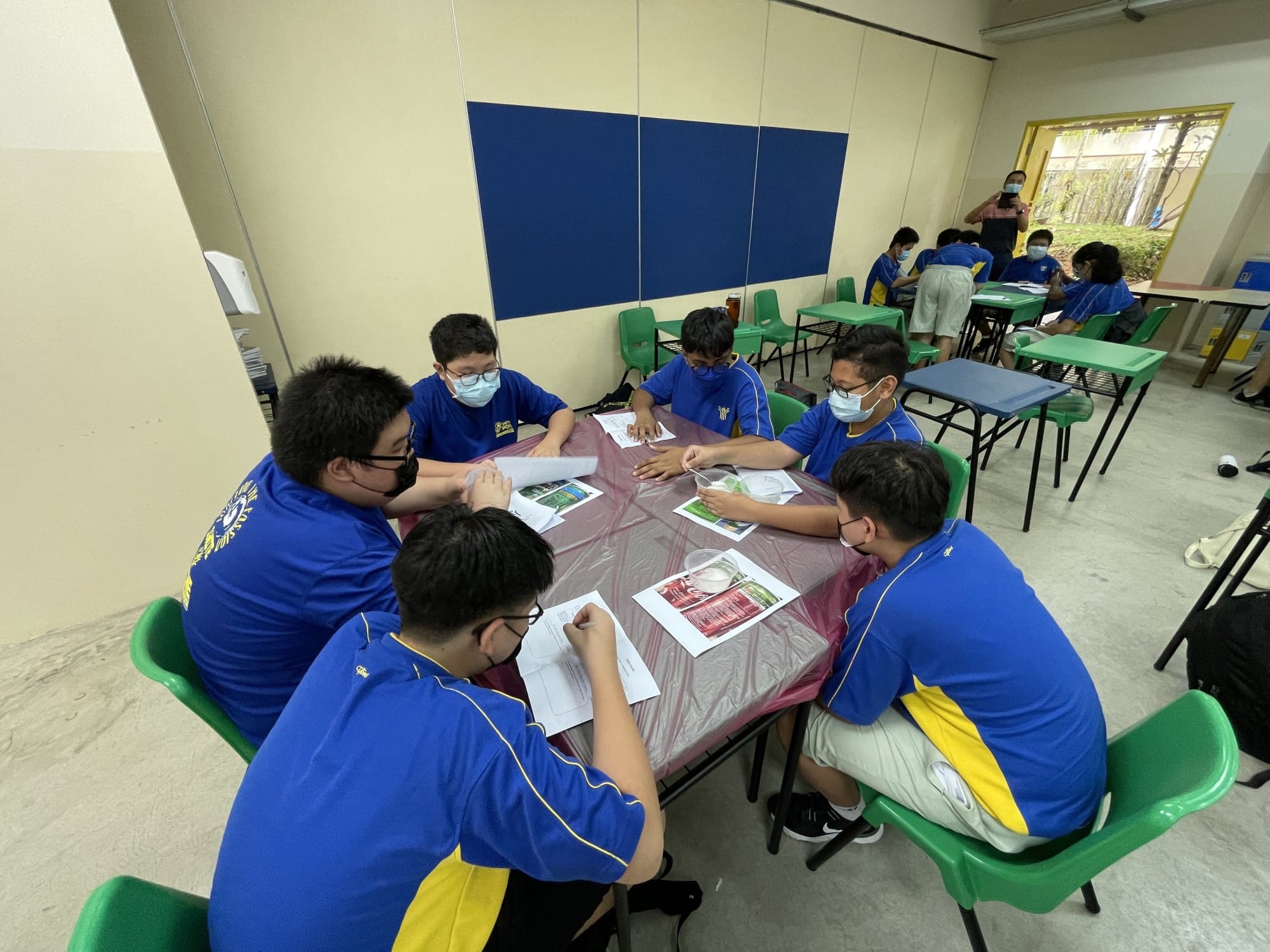 Students engaged in a group discussion in class during PE lessons.