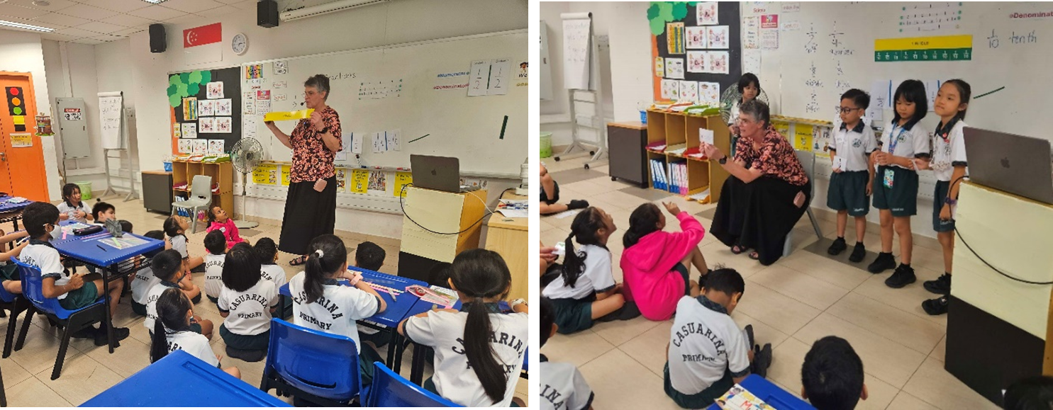 A teacher instructs Casuarina Primary School students in a classroom, with children seated at desks and on the floor.