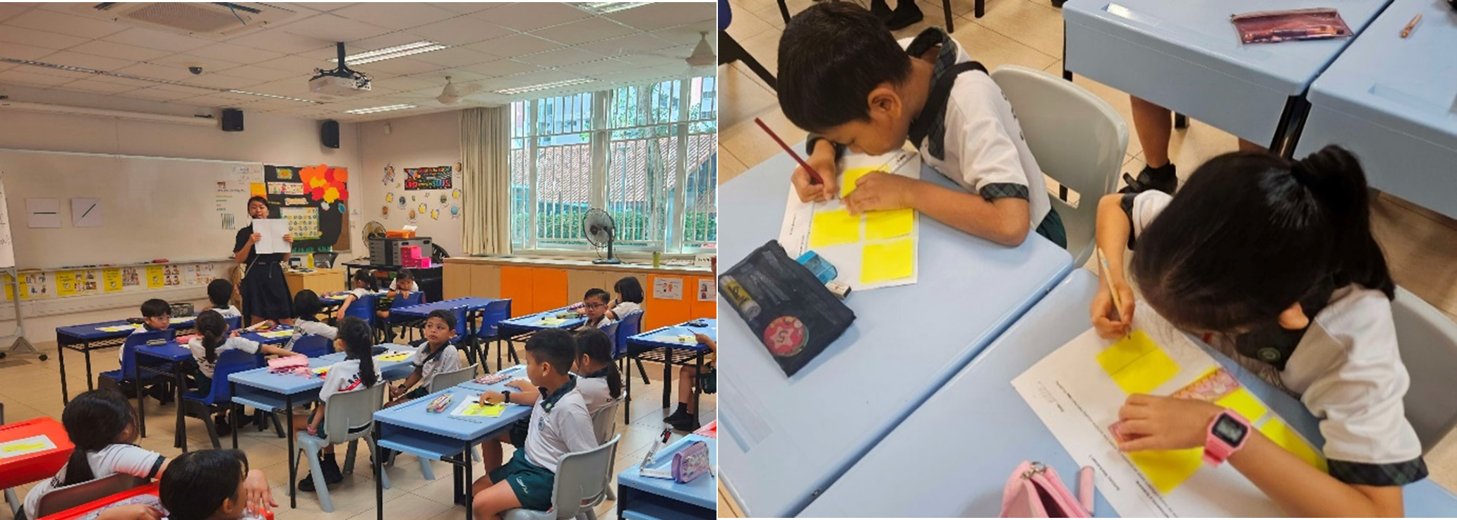 Young students in school uniforms sit at desks in a classroom while two children write on yellow sticky notes.