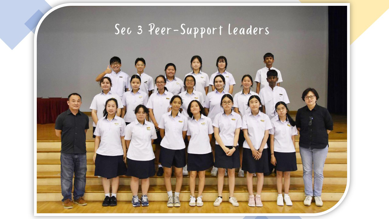 Group photo of Sec 3 Peer-Support Leaders in school uniforms posing in rows on wooden bleachers.