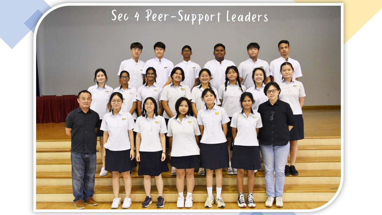Group photo of Sec 4 Peer-Support Leaders in white uniforms posing in rows on wooden steps.
