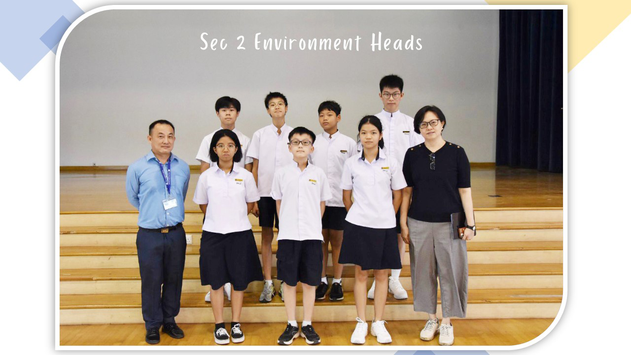 Group photo of Sec 2 Environment Heads, six students in white uniforms posing with two adult teachers indoors.