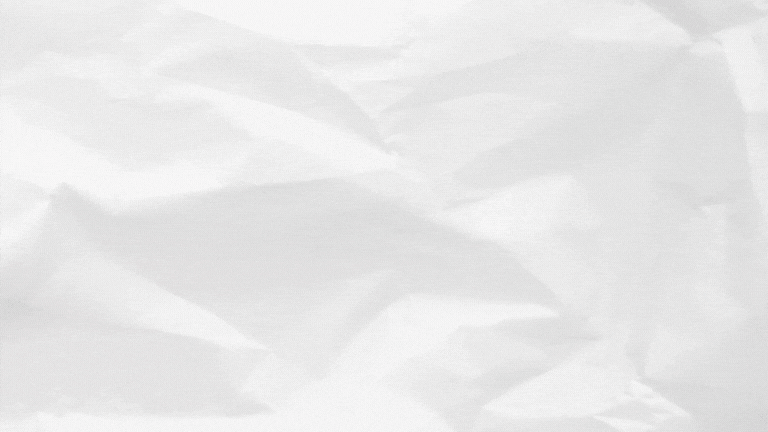 Light gray crumpled paper texture with soft folds and wrinkles across the surface.