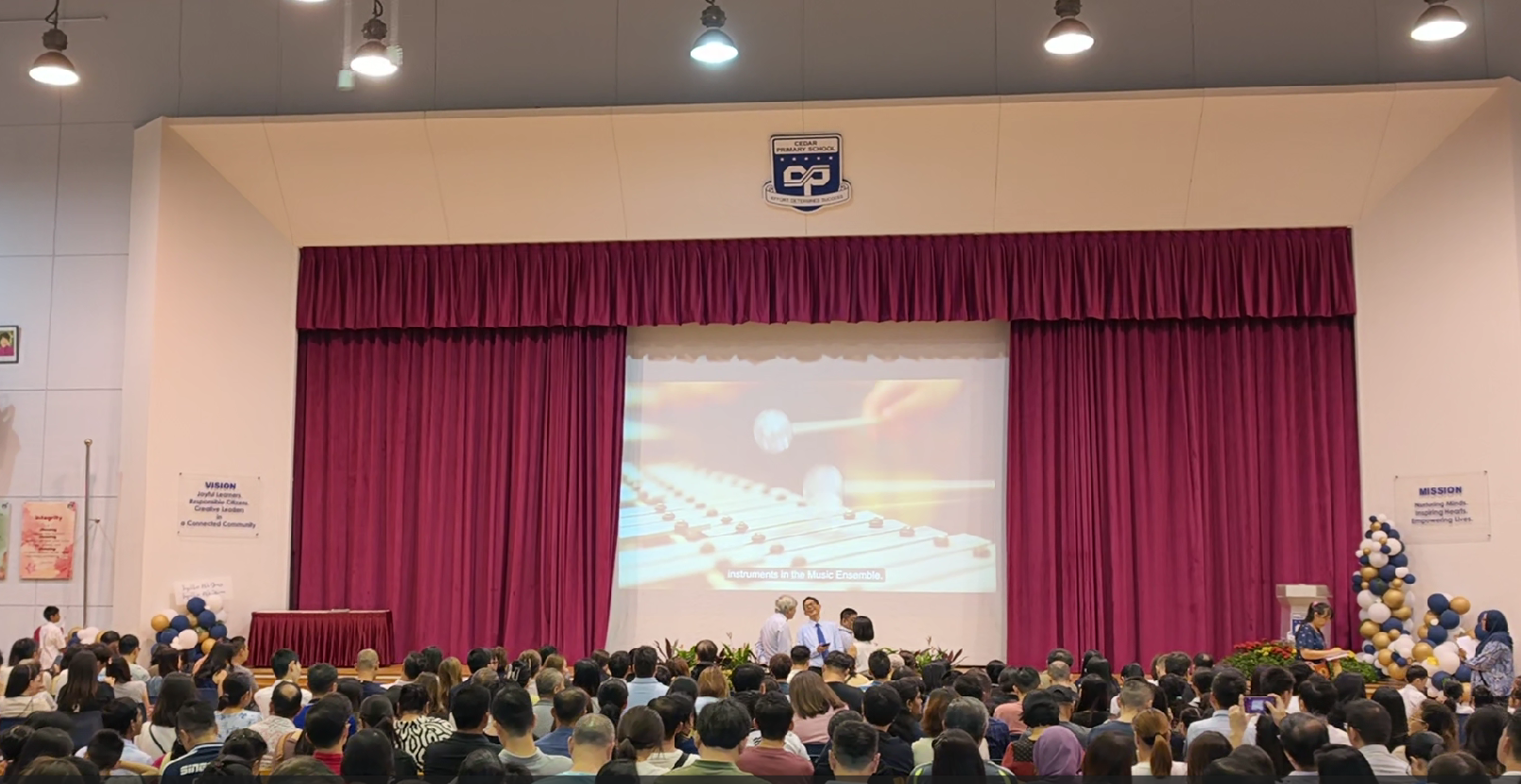 Photo of parents gathered in school hall to celebrate year end event