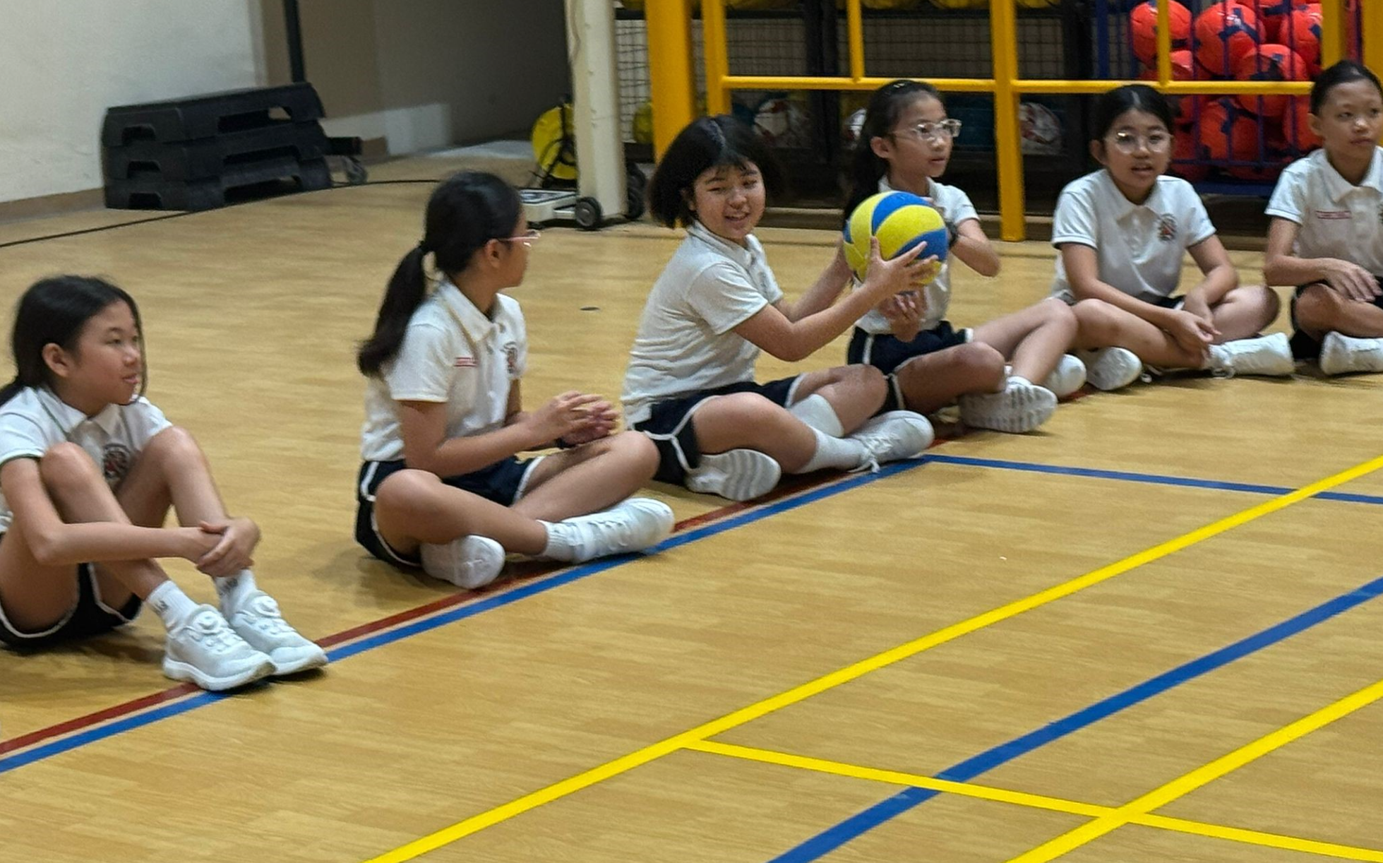 Students passing a ball to one another