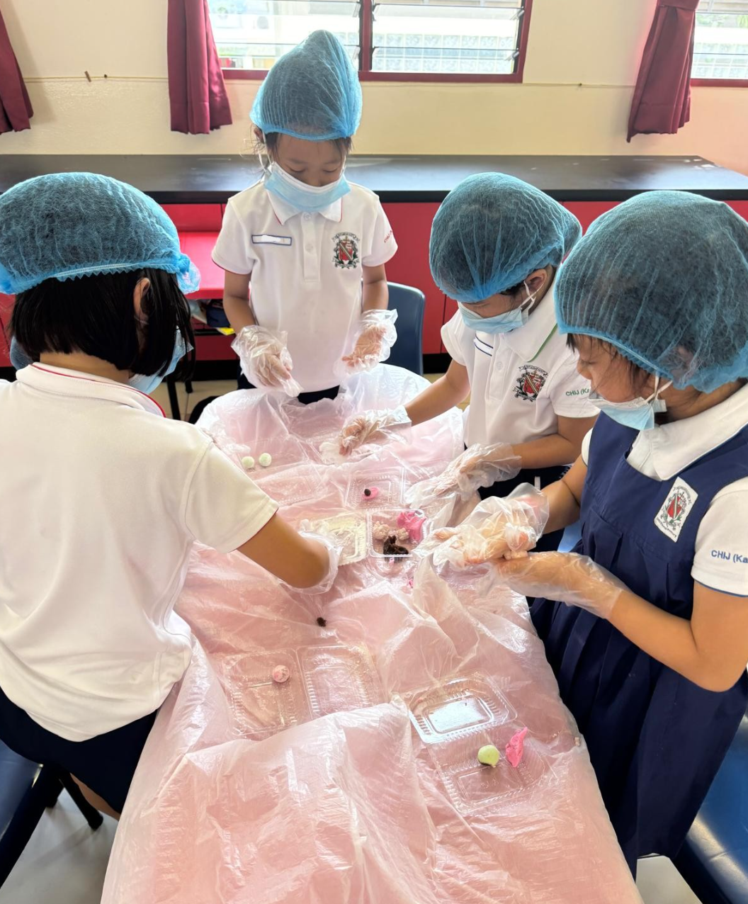 IJ girls making kuehs in classroom