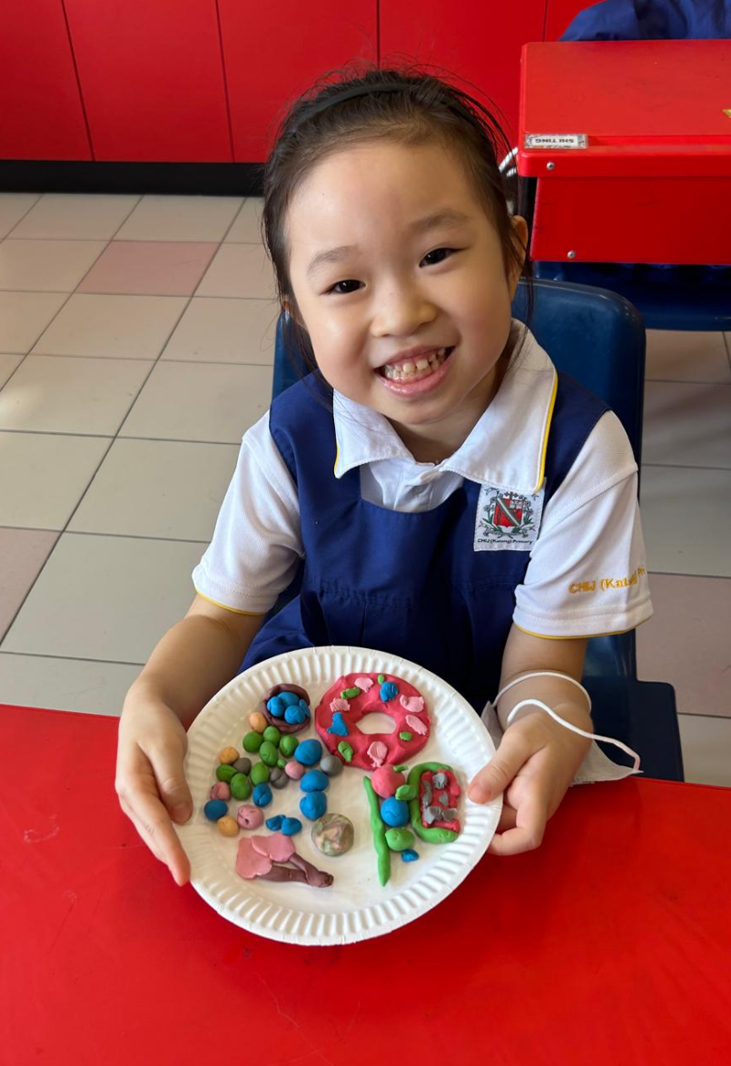 Student displaying her completed art work
