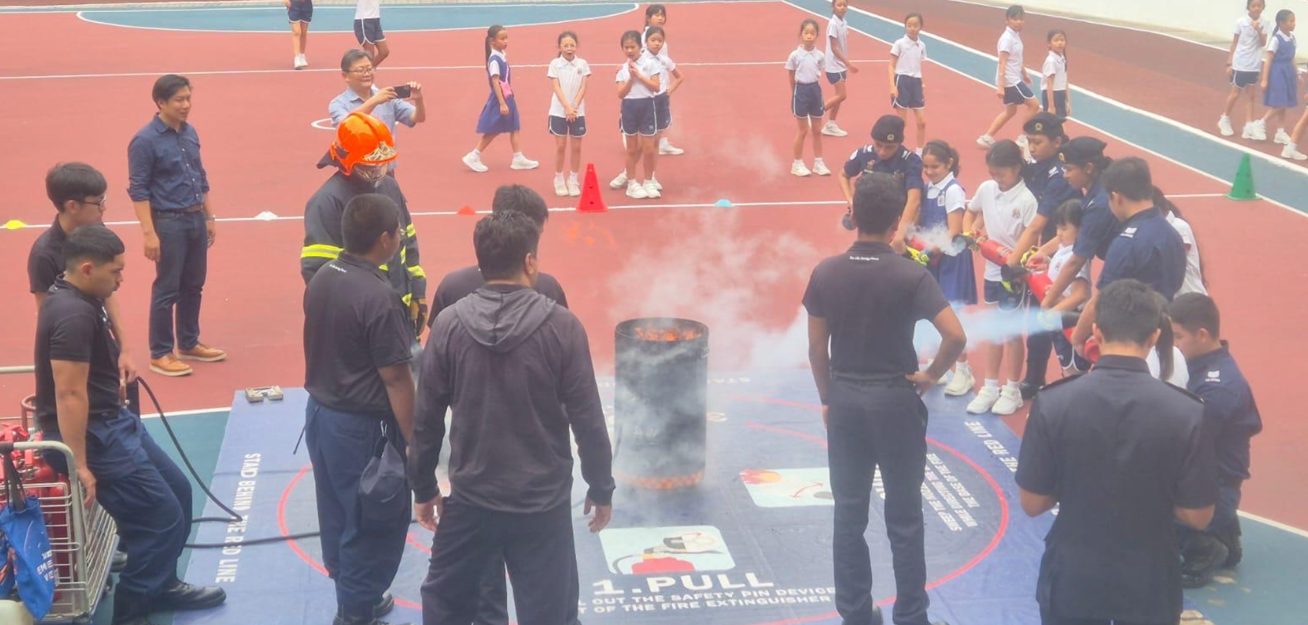IJ girls learning how to put out a fire