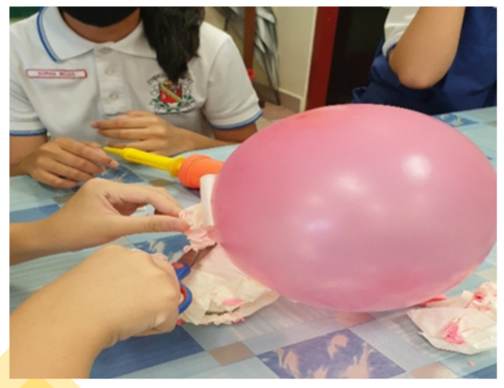 Students conducting an experiment using balloons