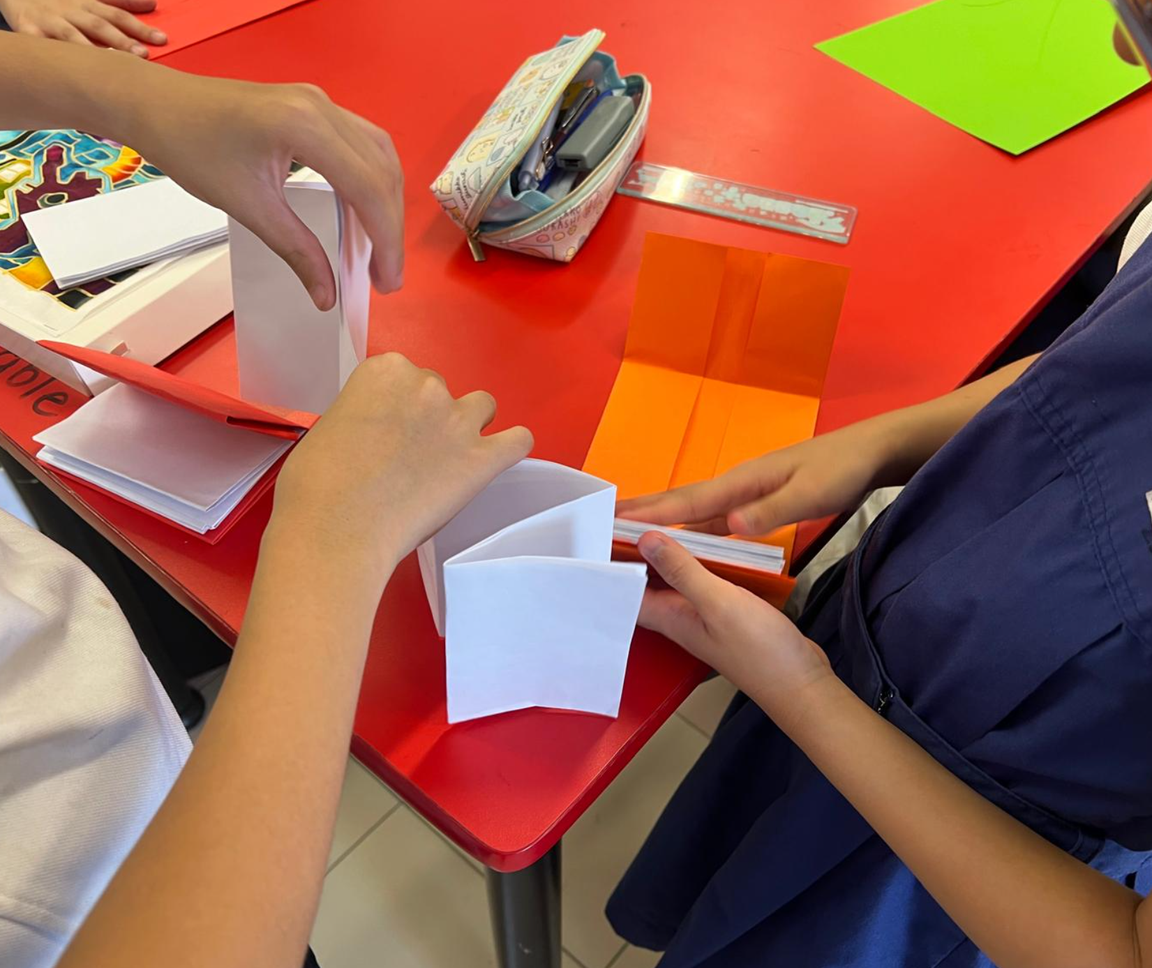 Students folding papers during Art Club CCA