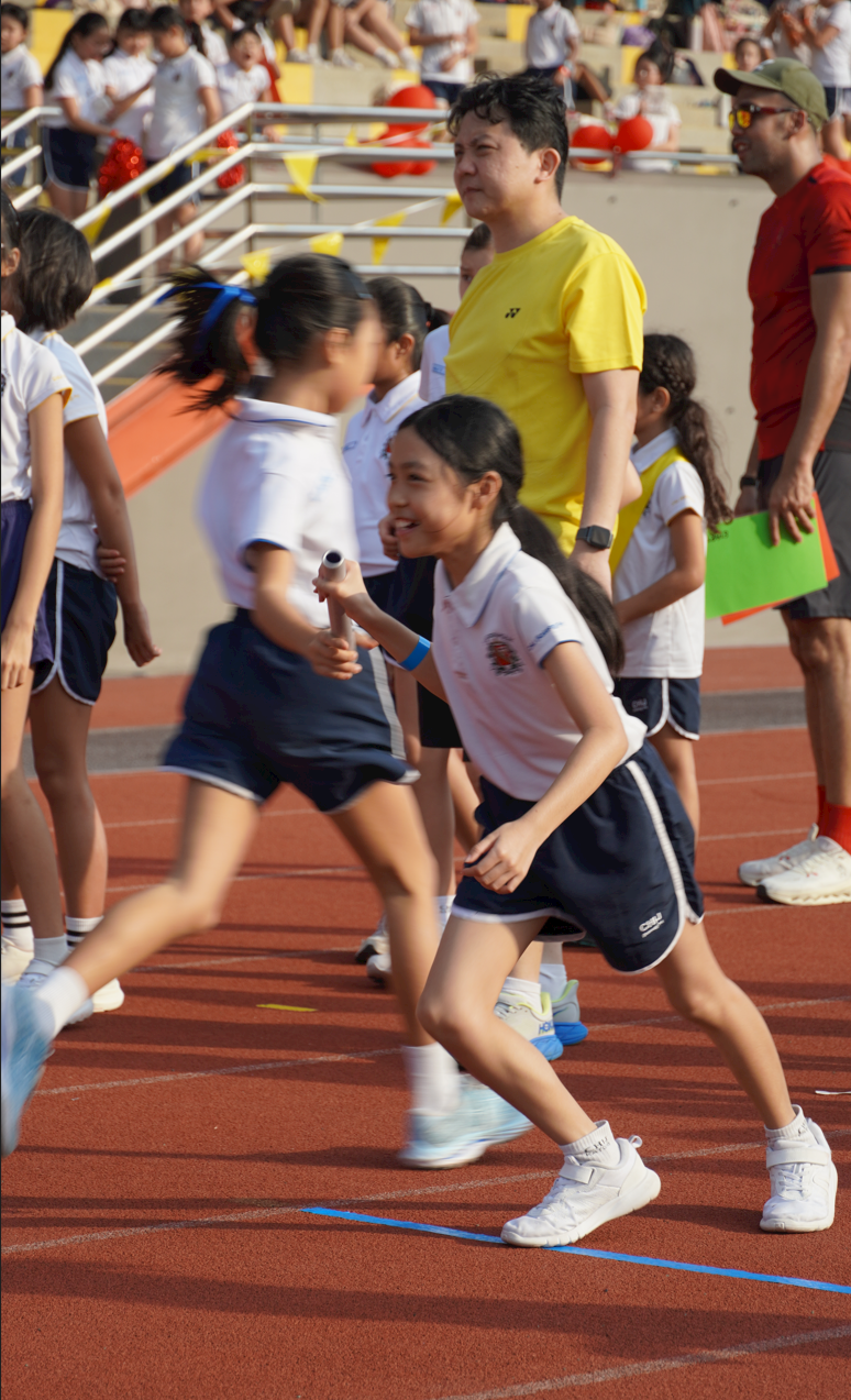 Student receiving baton during the relay race