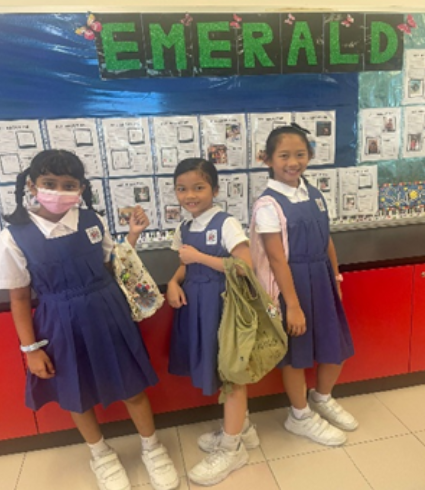 Students posing with recycled bags