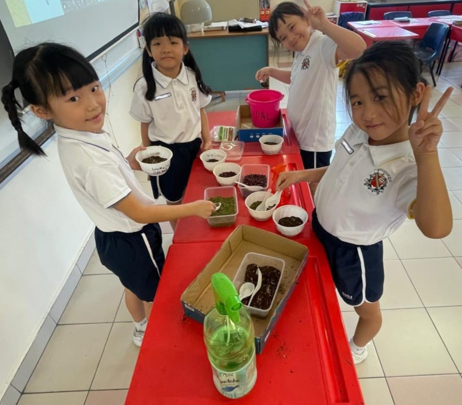 Students using soil to prepare the art work