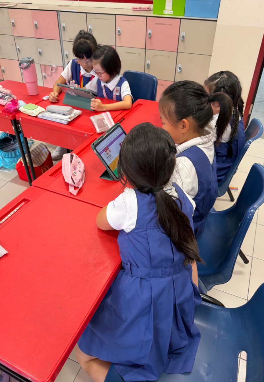 IJ girls using iPads in classroom during lesson