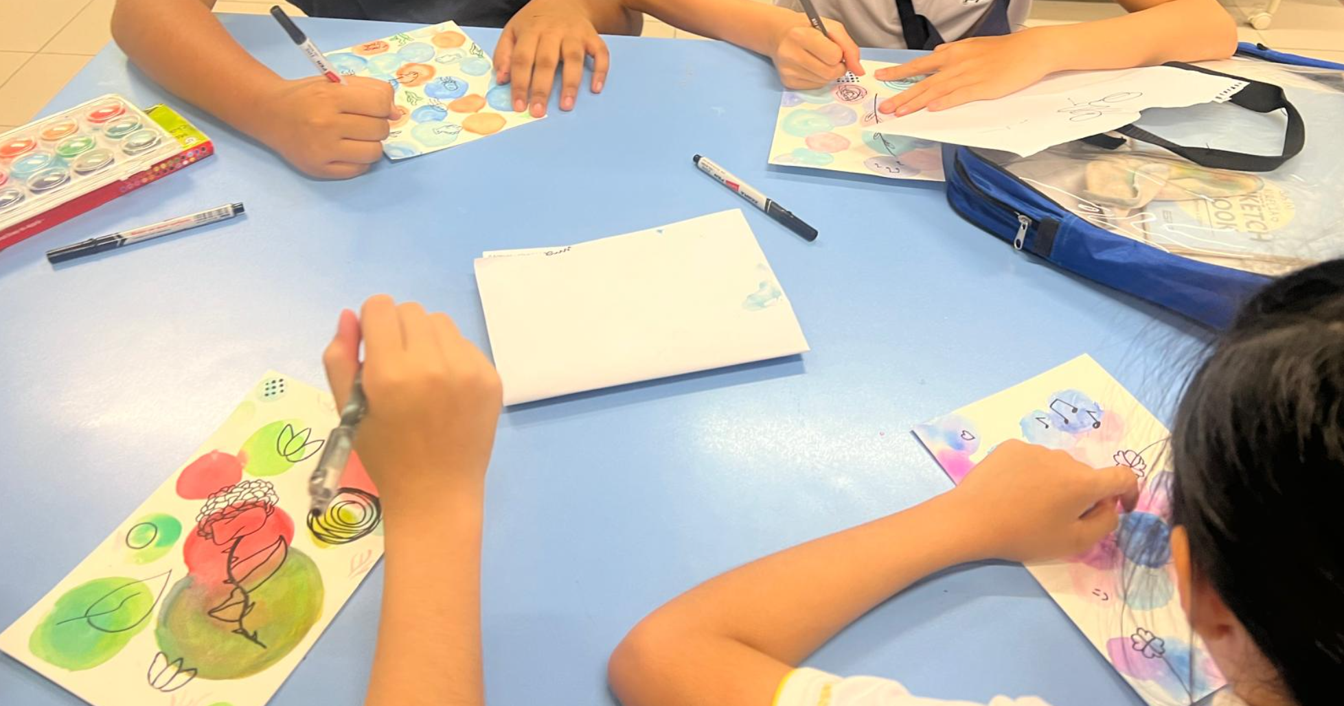 Art Club CCA students colouring their art pieces
