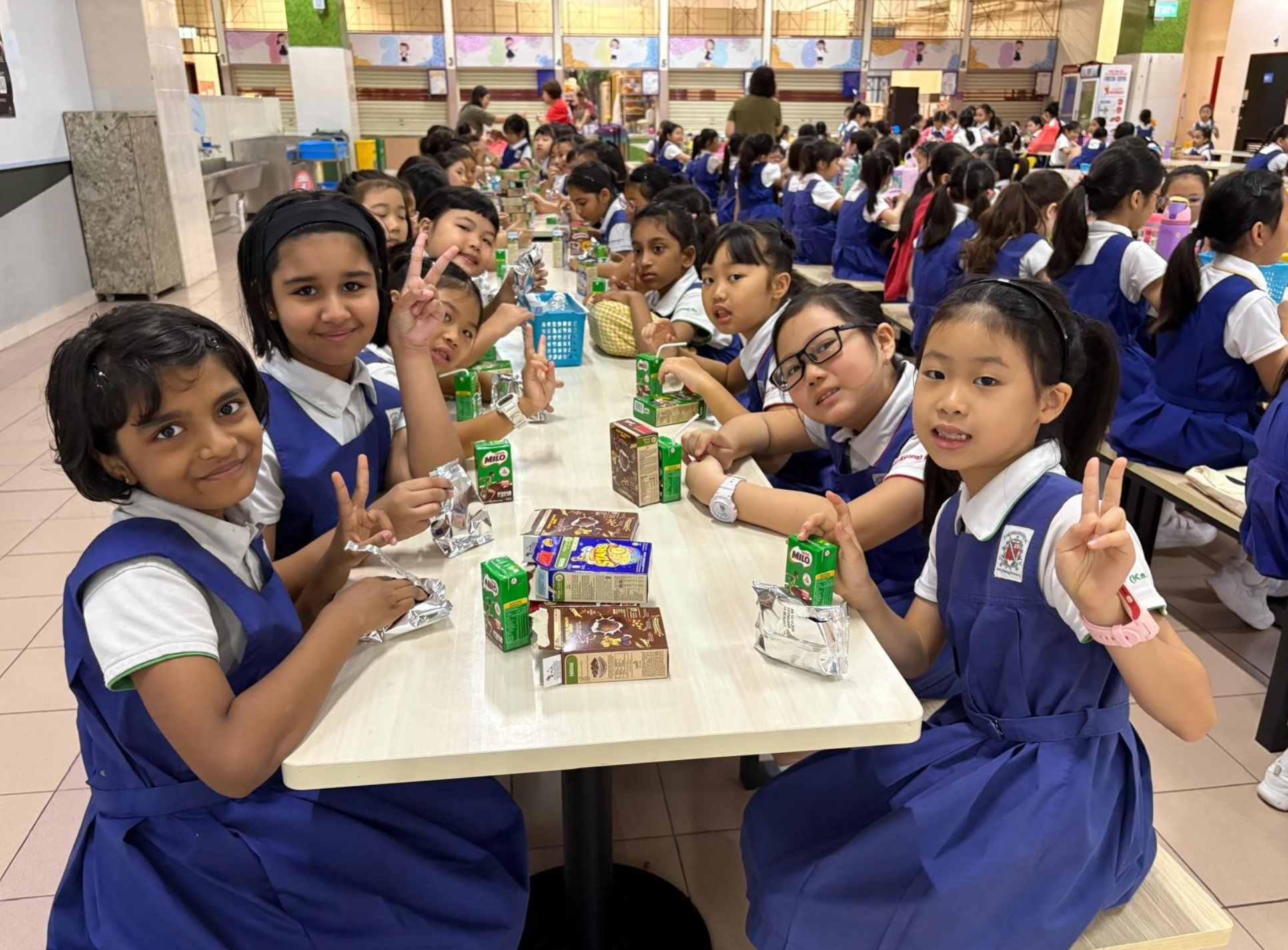 Students taking snack break in school canteen