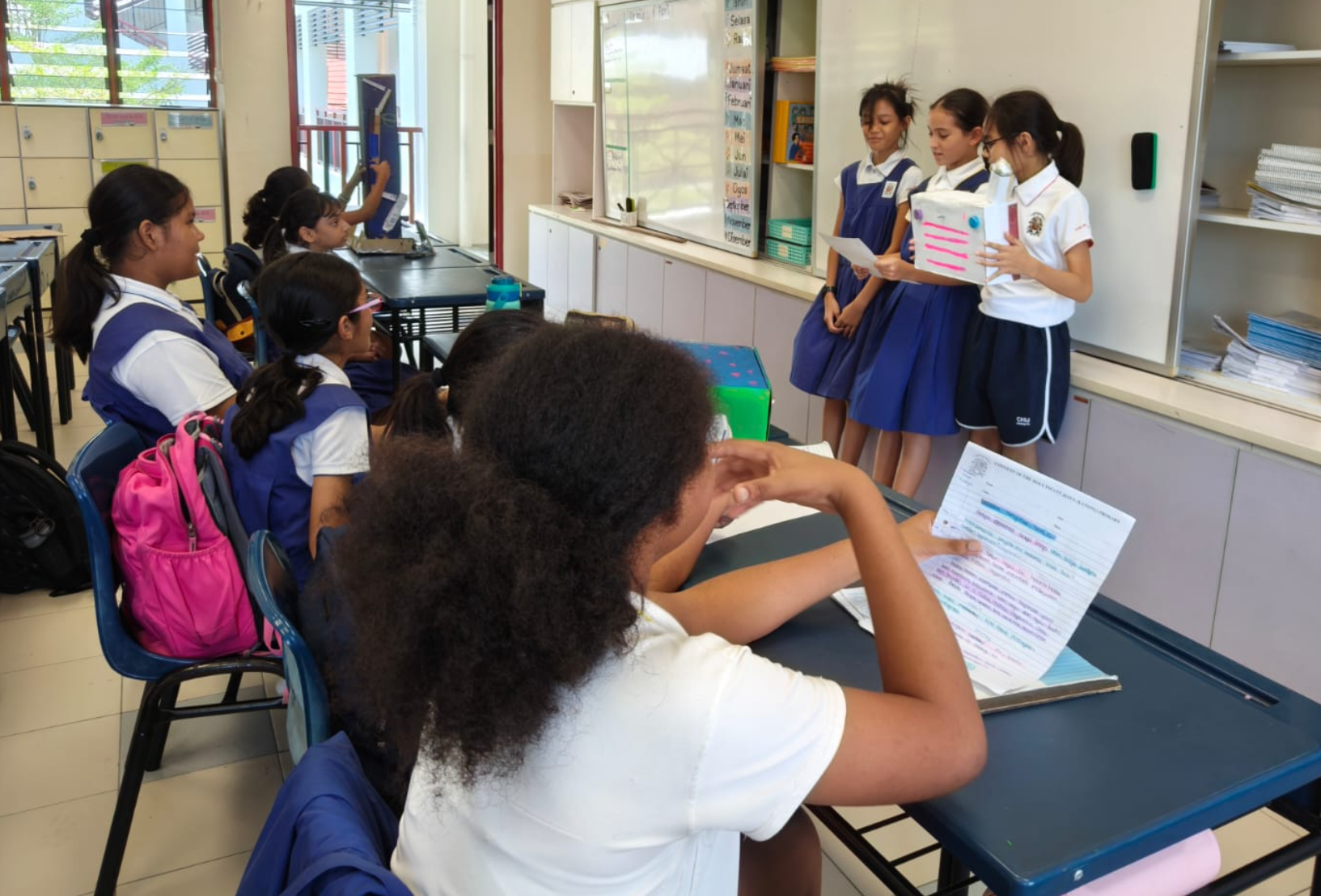 Group of IJ girls presenting to their classmates in Malay