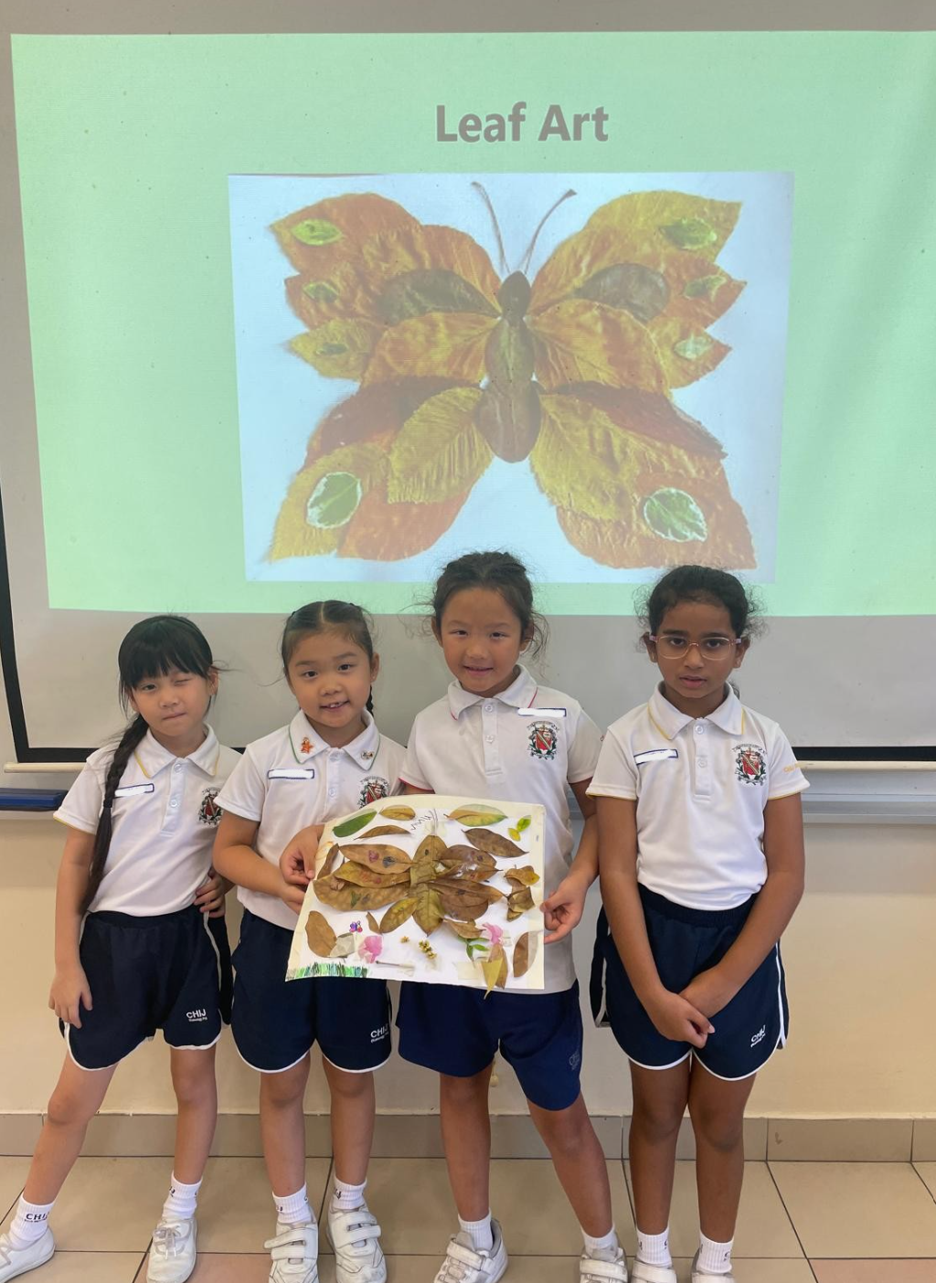 Students displaying their completed art work
