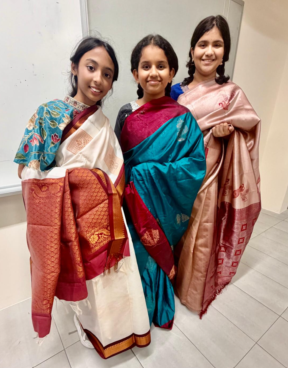 IJ girls learning how to wear traditional Indian costume