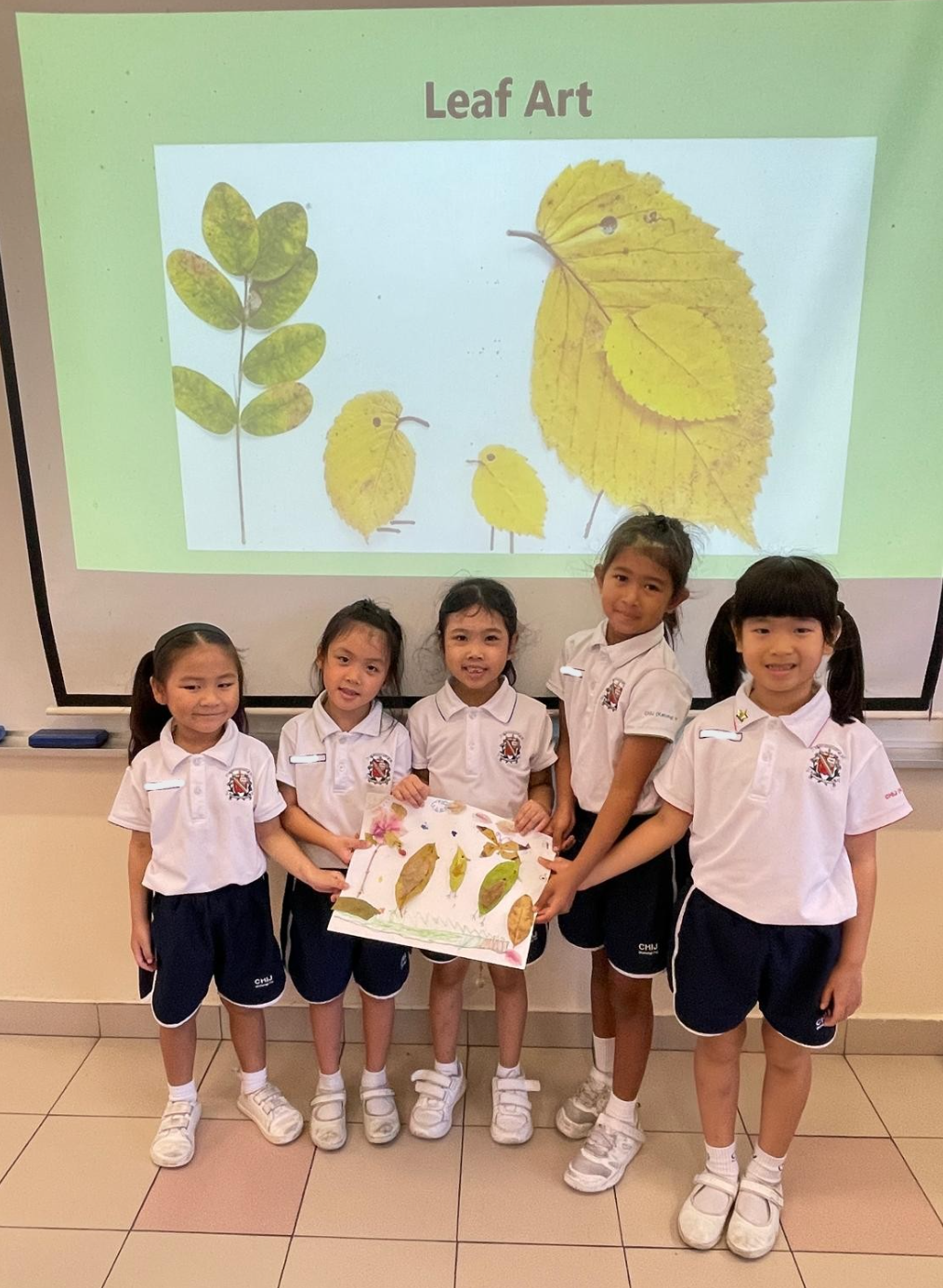 Students showing the completed leaf art