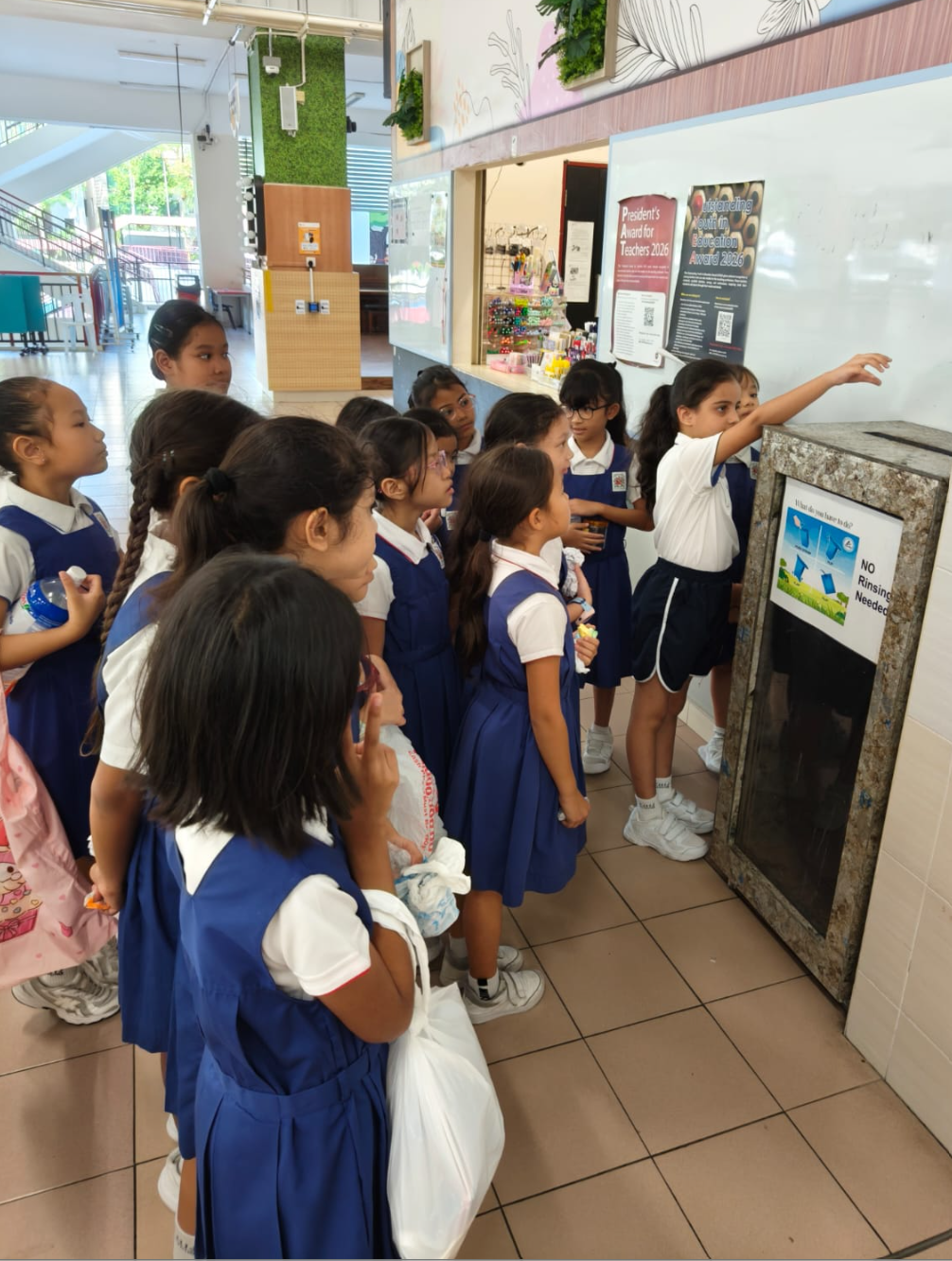 IJ girls practice recycling in school canteen