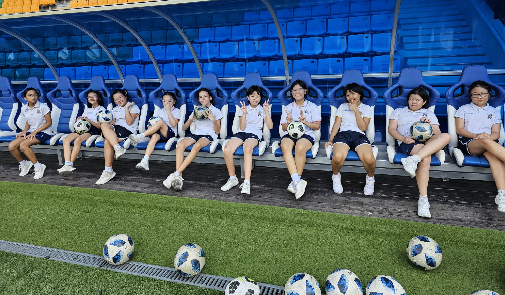 Sports Club girls seating on bench at Jalan Besar Stadium