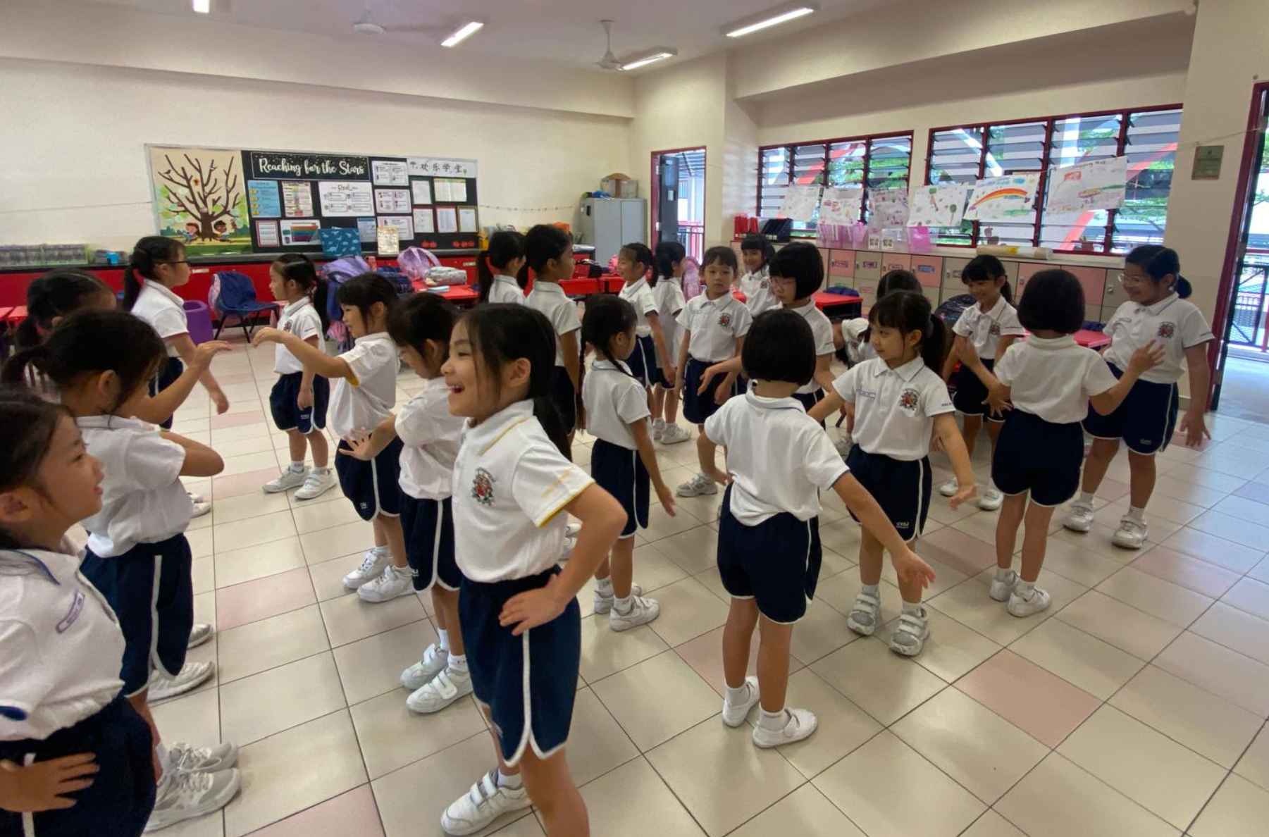 Students warming up before drama lesson begins