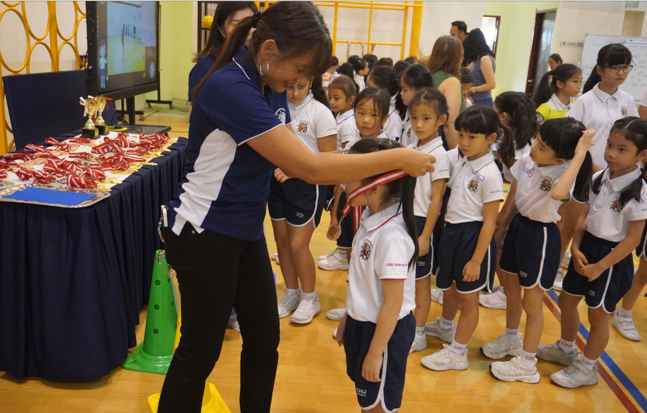School Principal presenting medals to the winners