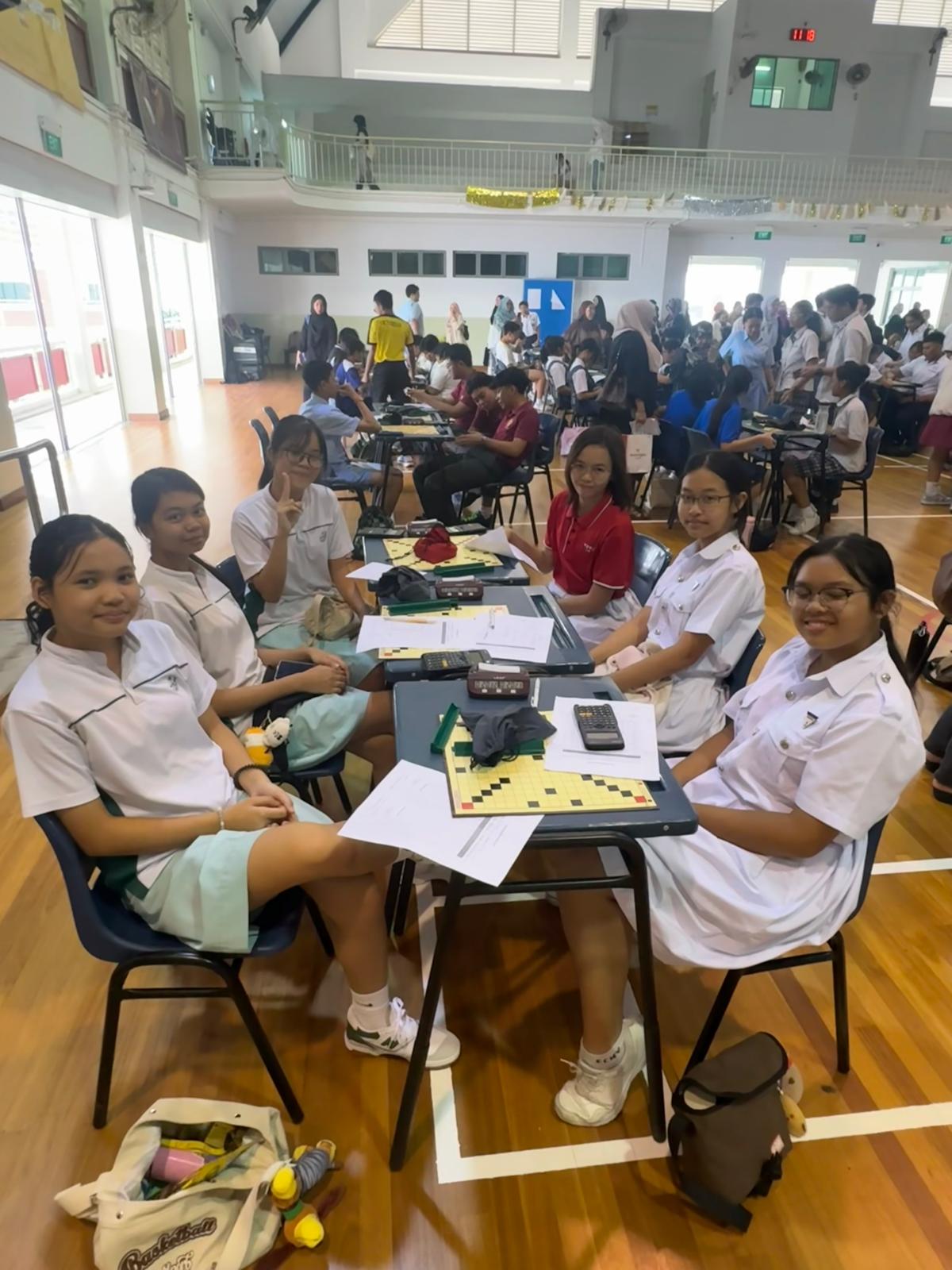 A group of girls from different school sitting on a chair