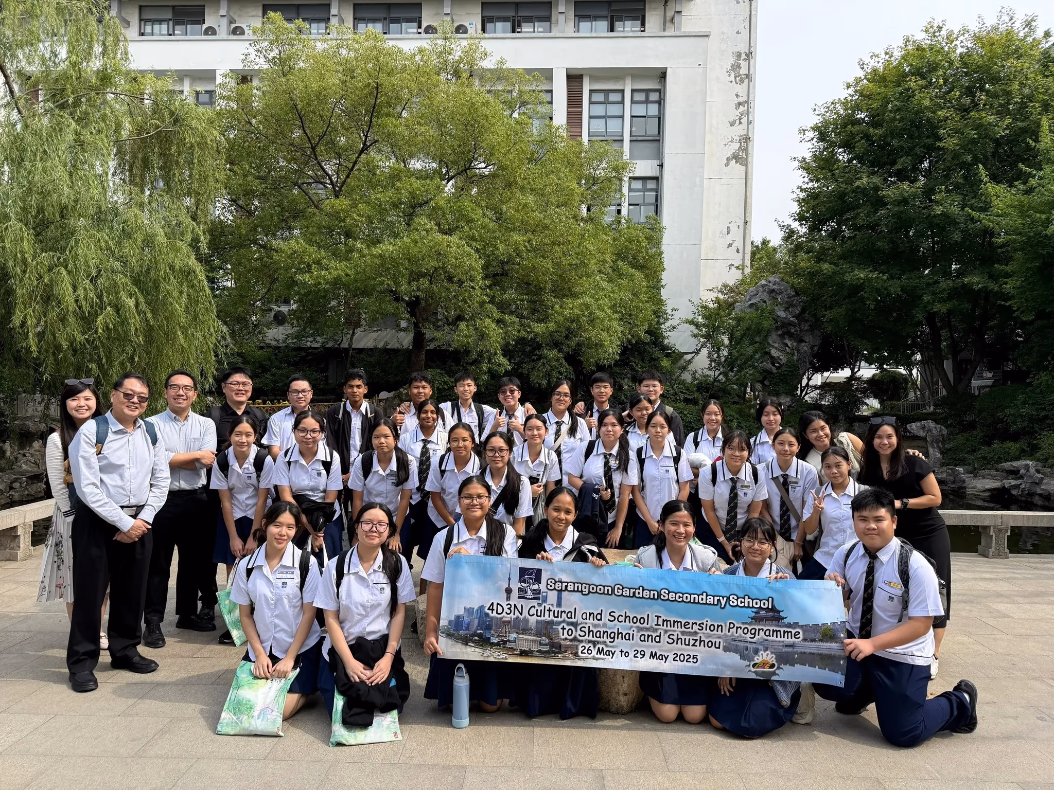 Students and teachers from Serangoon Garden Secondary School pose with a banner for a Shanghai and Shuzhou trip in May 2025.