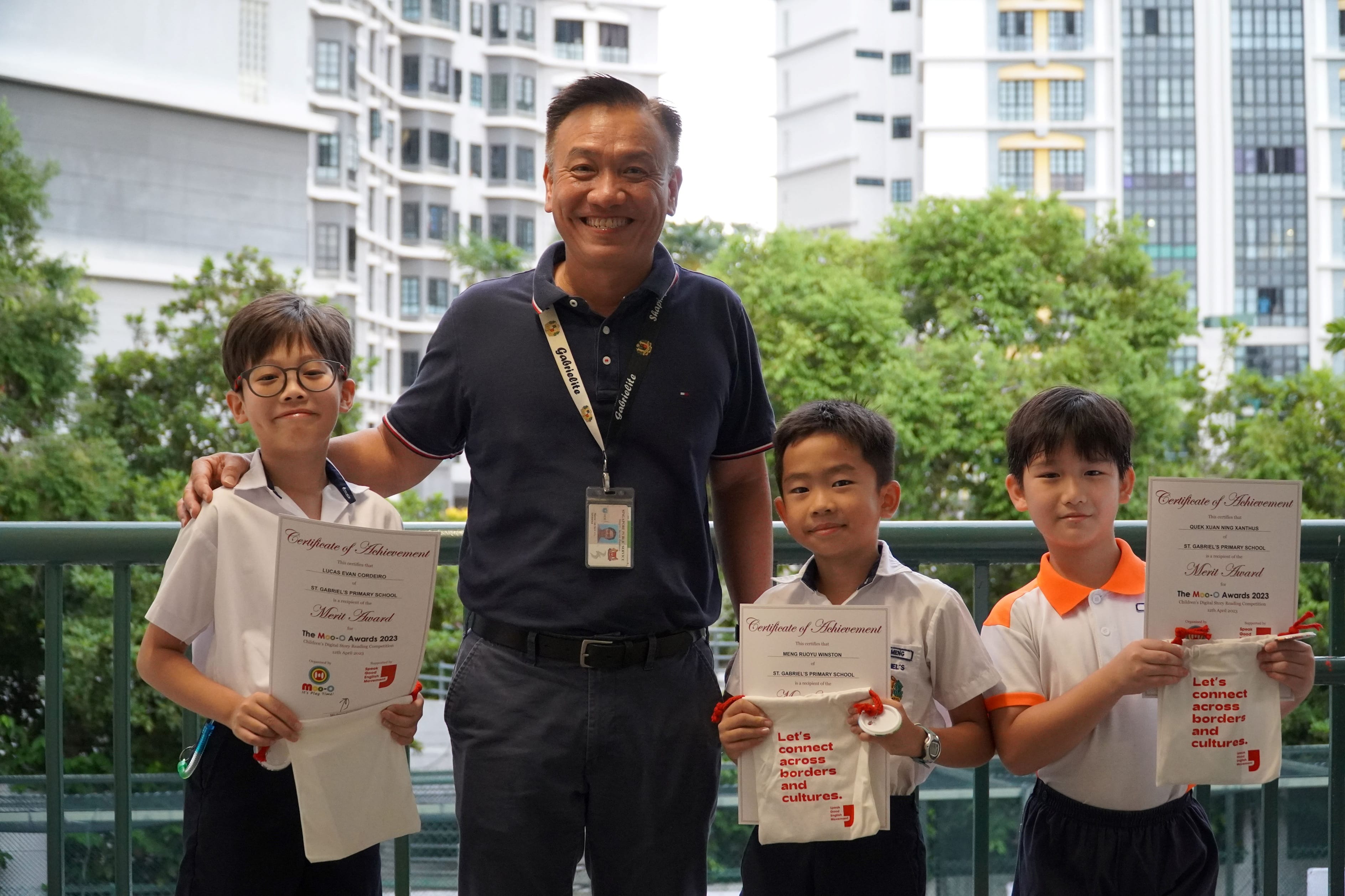 Three student winners taking a photo with the school's Principal