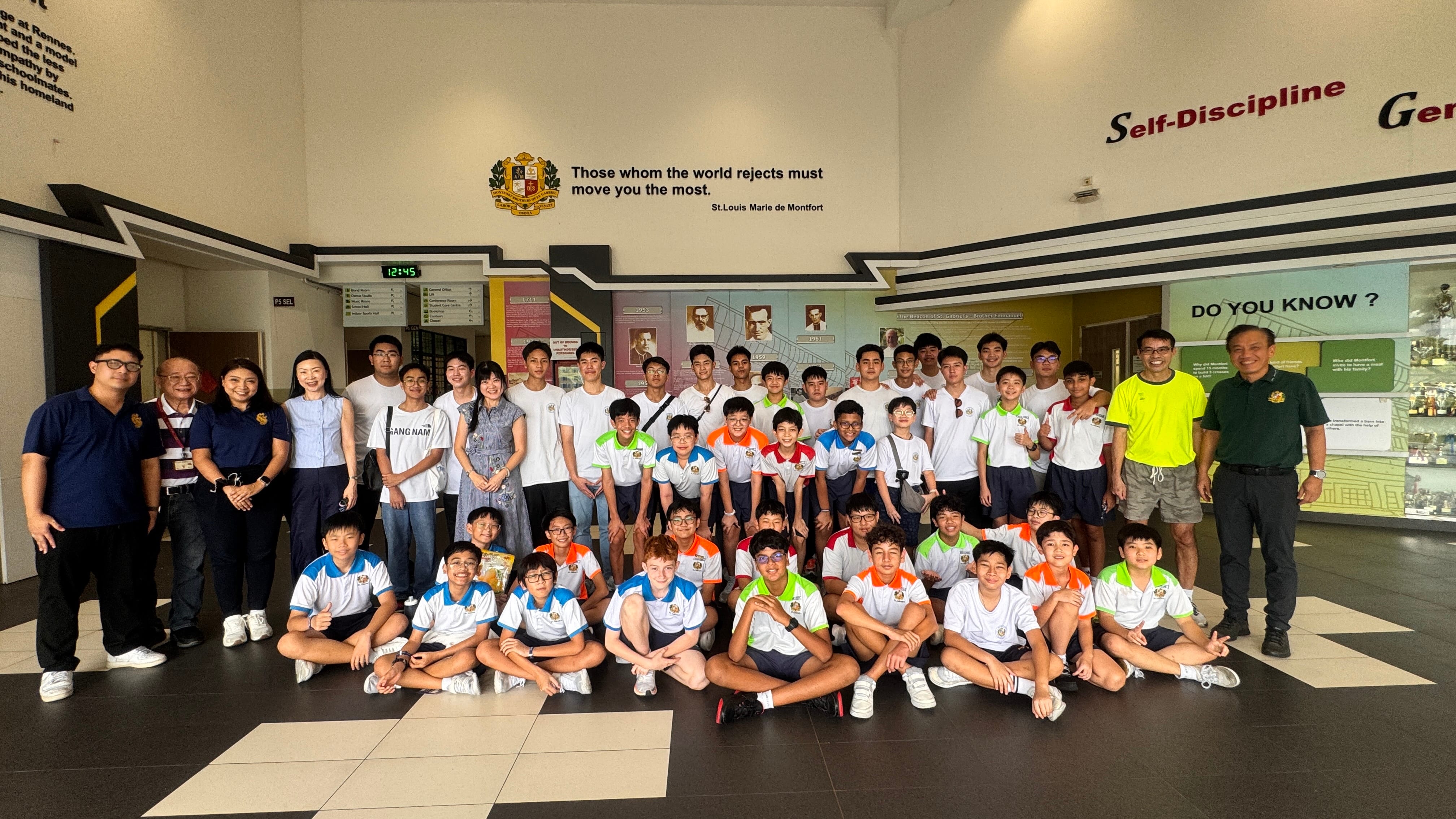 Group photo of students and teachers at the Foyer